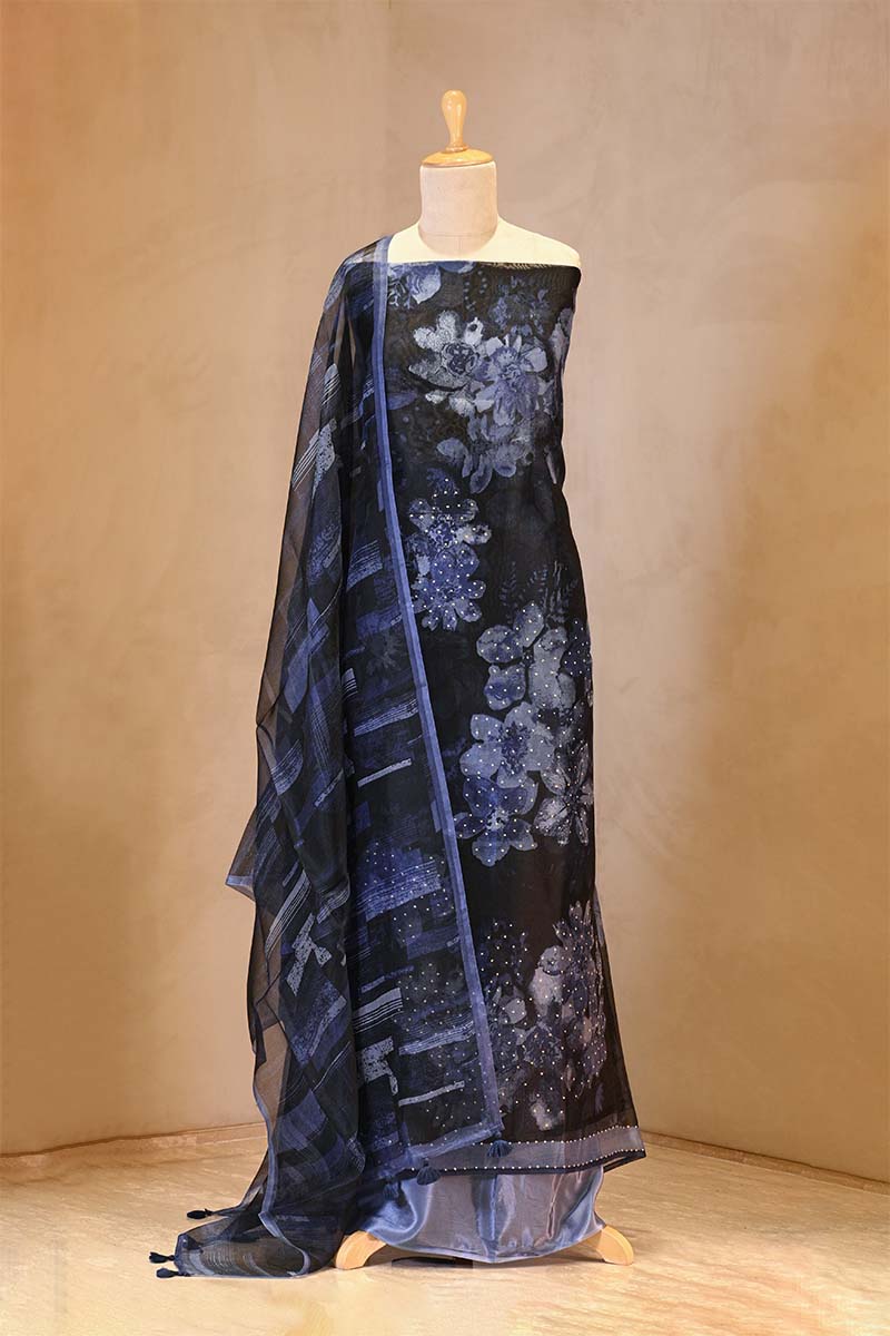 Blue floral patterned fabric draped over a mannequin against a beige background