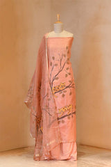 Peach-colored saree with tree and leaf design on a mannequin against a beige background