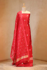 Red saree with white patterns on a mannequin against a beige background