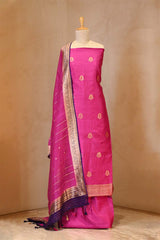 Pink saree with gold border on a mannequin against a beige background