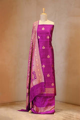 Purple saree with gold patterns on a mannequin against a beige background