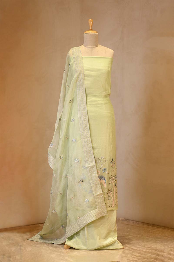 Light green saree with embroidery on a mannequin against a beige background