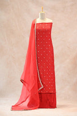 Close up of floral silver zari meenakari and bandhej buti detailing on red Chiniya silk unstitched suit set kurta.
