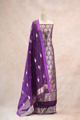 Large-scale gold zari woven ethnic floral bootas on wine Banarasi Katan silk fabric paired with a purple organza dupatta featuring Matsya motifs.