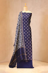 Navy blue saree with white polka dots and border on a mannequin against a beige background