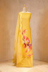Yellow dress with floral design on a mannequin against a beige background
