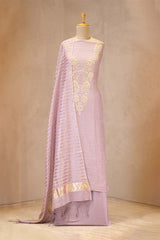 Light purple saree with gold embroidery on a mannequin against a neutral background