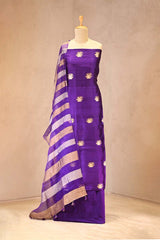 Purple suit set with gold patterns on a mannequin against a plain background