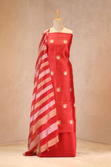 Red suit set with white stripes and gold patterns on a mannequin against a beige background