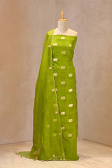Close up of Green Chiniya Silk Suit Set showing the unstitched top fabric with Gaja motifs and the organza dupatta with gota patti and cutdana border.