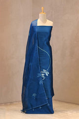 tie and dye Matsya (fish) motifs with Aari embroidery on a blue Chiniya silk unstitched suit set, paired with a tie-dye scalloped organza dupatta.