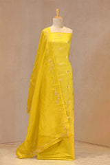 Gold zari woven ethnic ashva motif on yellow Chiniya silk unstitched suit set with an embroidered organza dupatta.