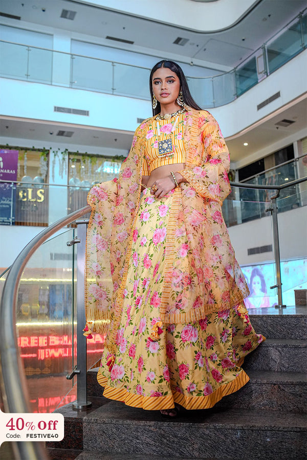 Woman in a yellow floral outfit standing in a modern indoor setting