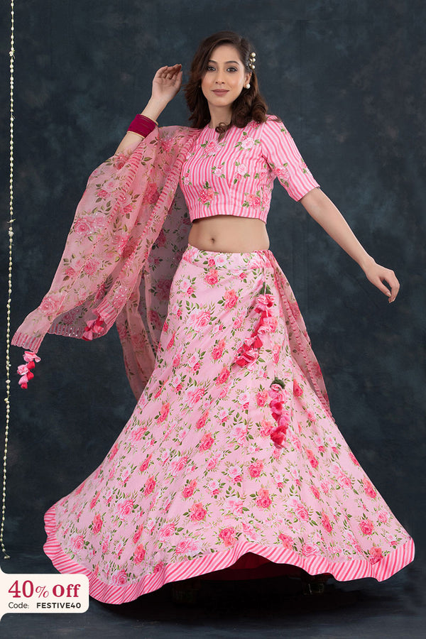 Woman wearing a pink floral traditional outfit with a dark background