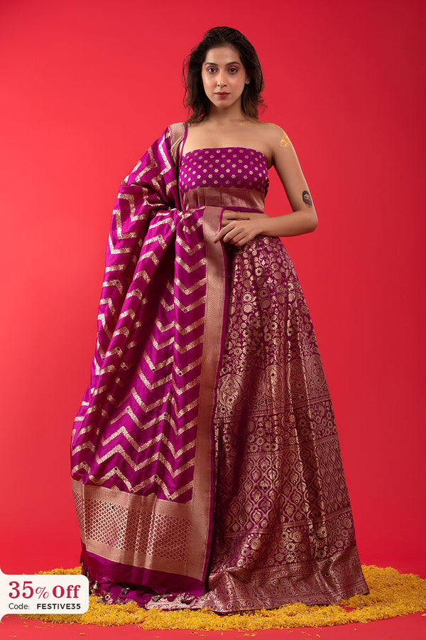 A bride wearing a designer purple lehenga with a promotional text sale offer on Lehenga up to 50%