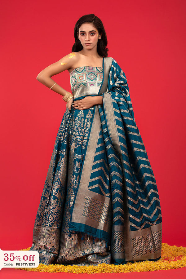 A bride in a traditional teal blue and golden Lehenga with a promotional text sale offer on Lehenga up to 50%