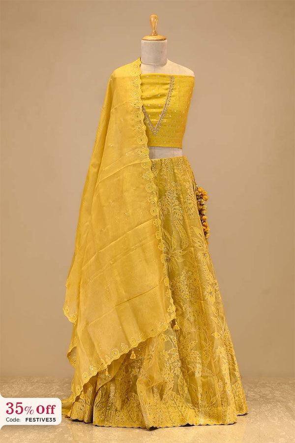 Yellow traditional lehenga on a mannequin with a promotional text sale offer on Lehenga up to 50%
