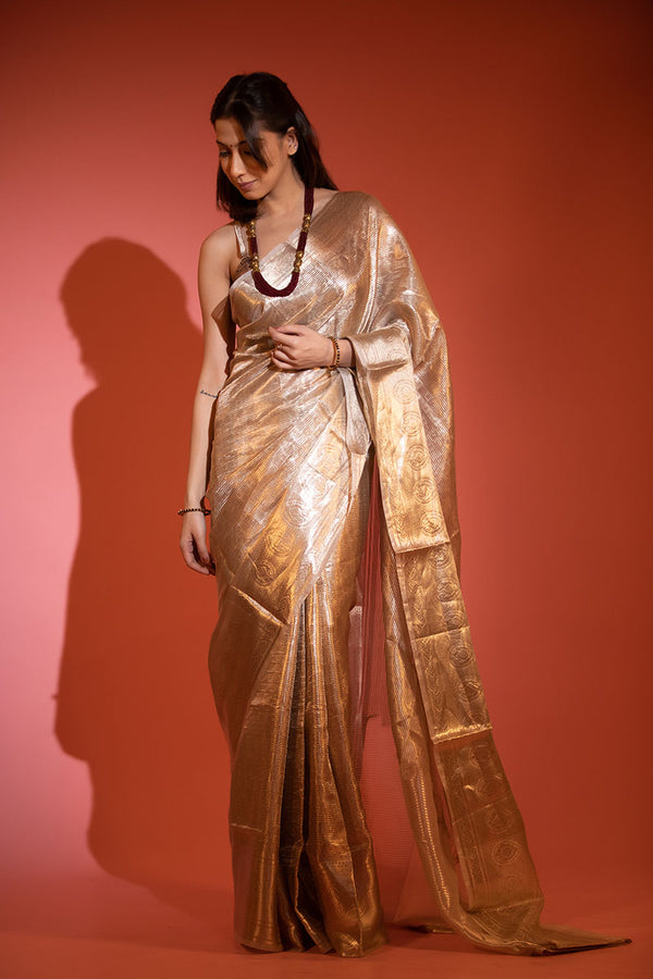 Women in Glittery Gold Handwoven Tissue Silk Saree at Chinaya Banaras