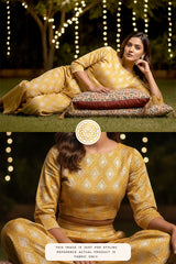 Woman in a yellow traditional outfit sitting outdoors with decorative lights.