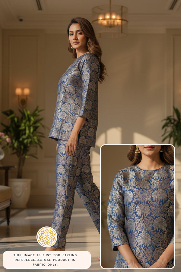 Woman wearing a Palm tree design blue Banarasi silk fabric made outfit in an indoor setting