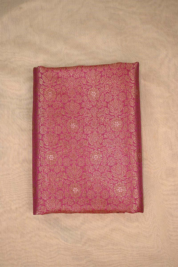 Decorative maroon fabric with intricate patterns on a beige background