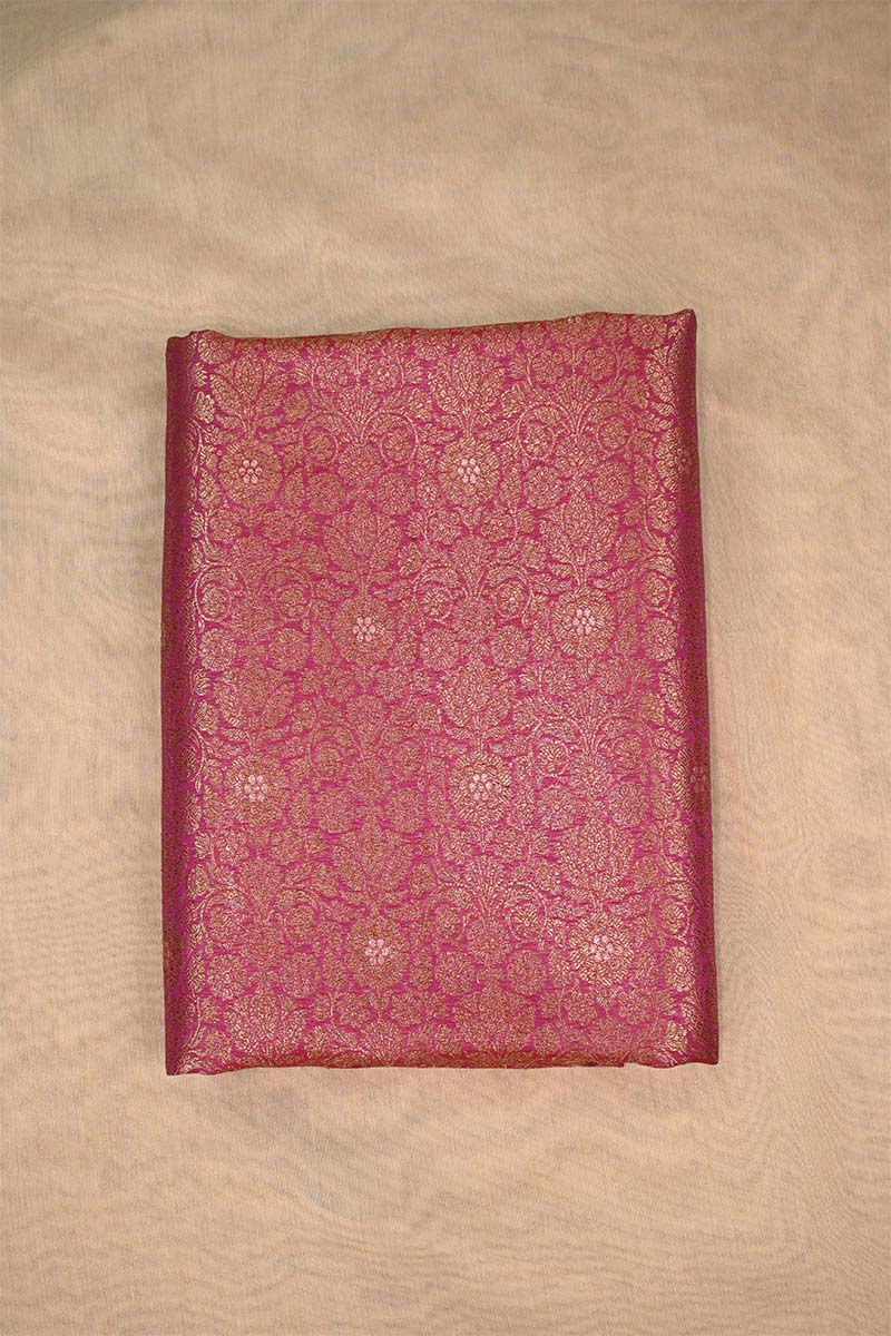 Decorative maroon fabric with intricate patterns on a beige background