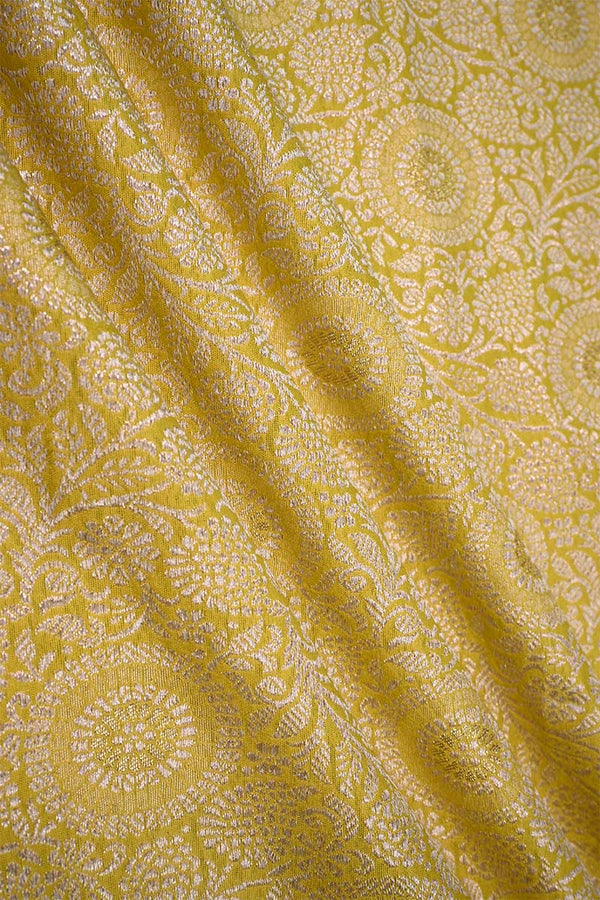 Yellow banarasi silk fabric with intricate floral weaving