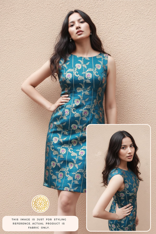 A woman wearing a blue floral Banarasi silk dress against a beige wall, with a close-up inset.