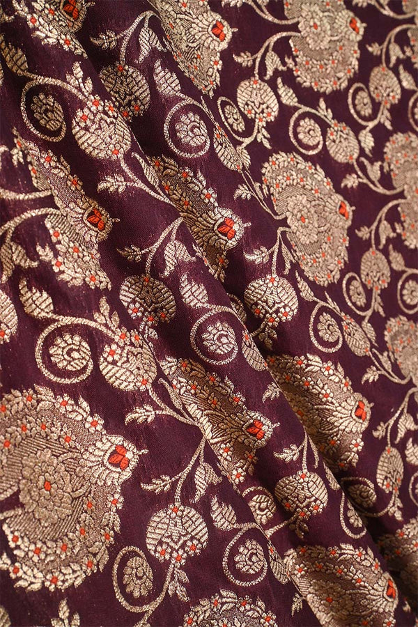 Close-up of floral patterned fabric with intricate design on a background wine 
