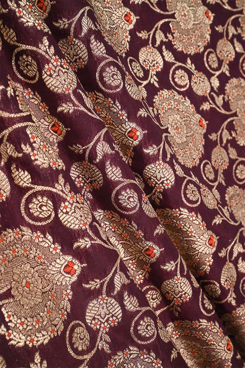 Close-up of floral patterned fabric with intricate design on a background wine 