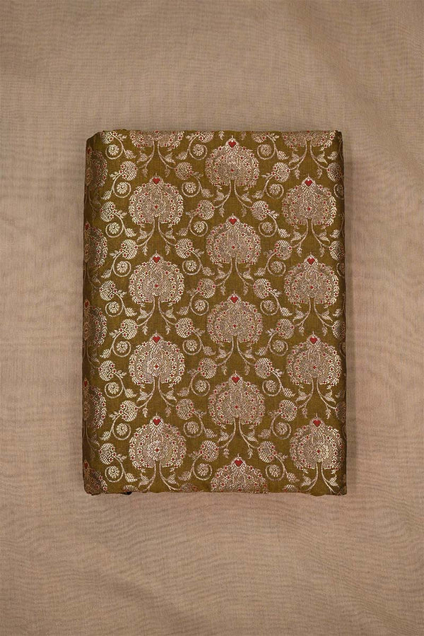 Close-up of embroidered woven Banarasi silk fabric with intricate patterns on beige background