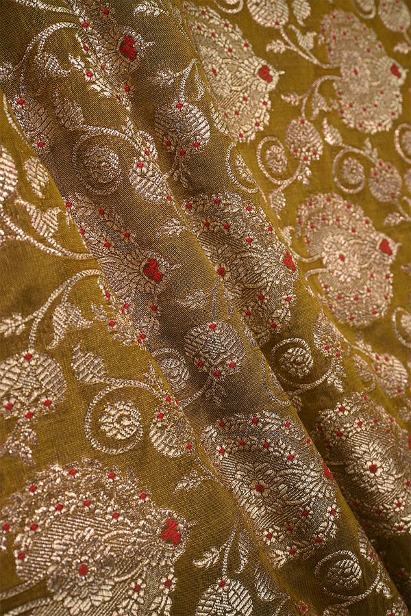 Close-up of embroidered woven Banarasi silk fabric with intricate patterns