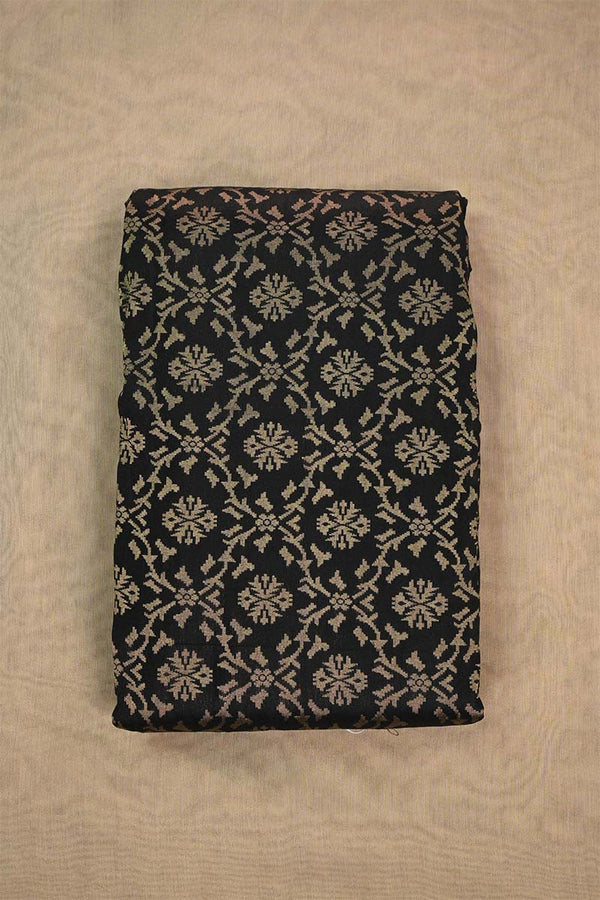 A black silk fabric with beige floral pattern woven with antique zari on beige background