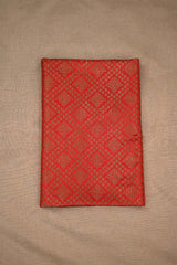 Red fabric with a diamond pattern on a beige background