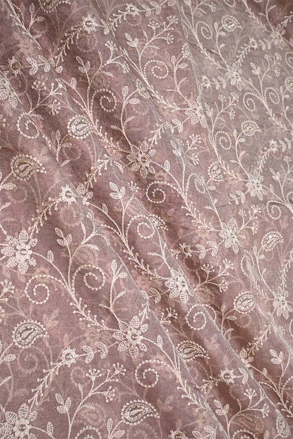 Floral and paisley patterned fabric with a soft mauve background