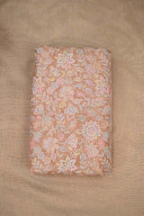 Close-up of multicolor floral pattern embroidered peach fabric  on beige background