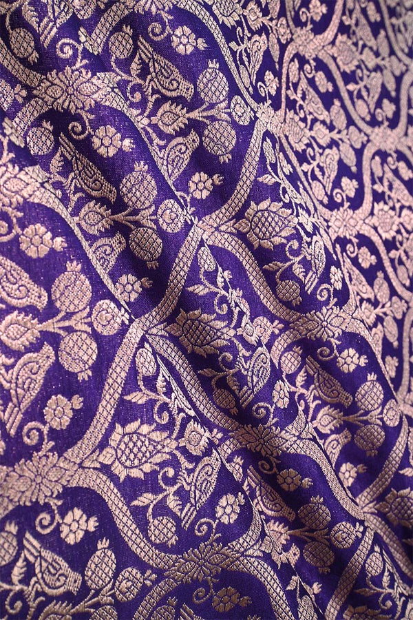 Close-up of a purple Banarasi silk fabric with a subtle floral pattern