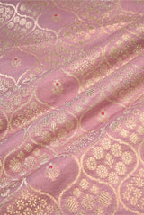 Close-up of pink fabric with gold embroidery