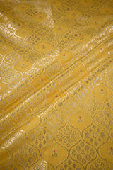 Yellow fabric with intricate gold patterns