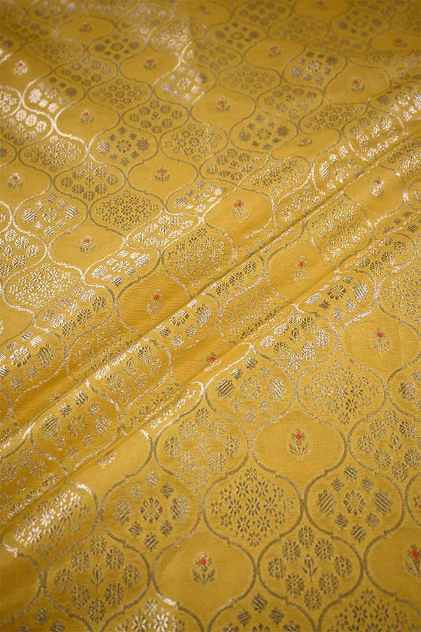 Yellow fabric with intricate gold patterns