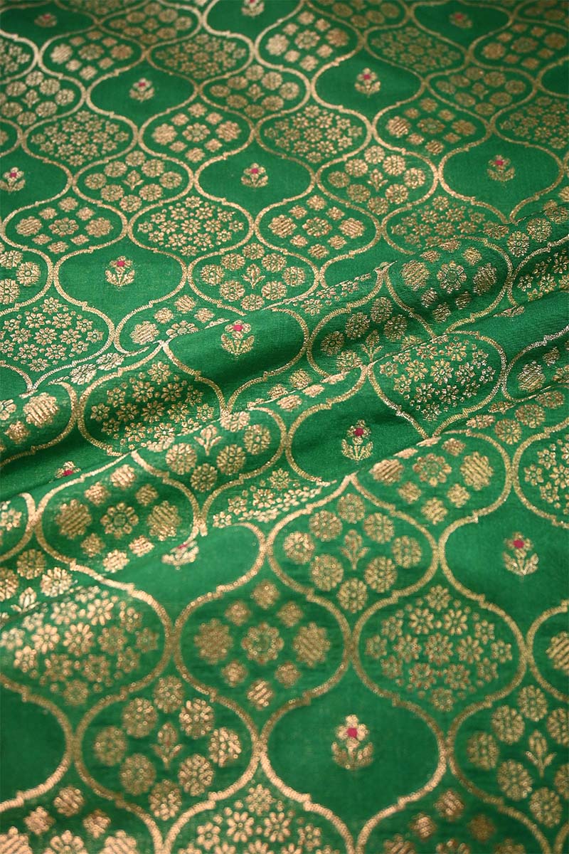 Close-up of green fabric with gold floral patterns