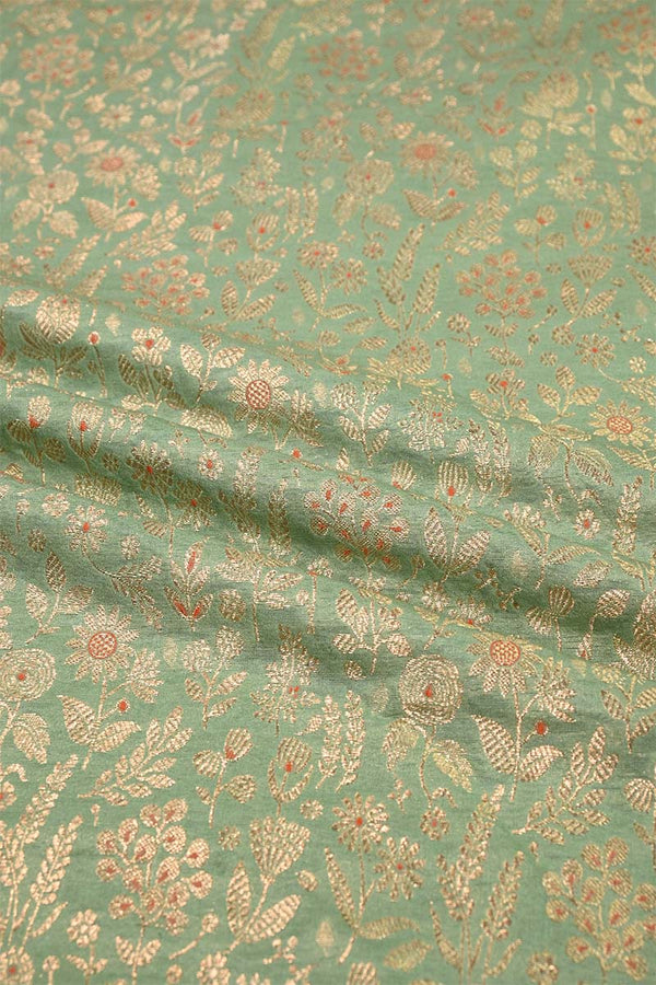 Textured fabric with floral pattern on a green background