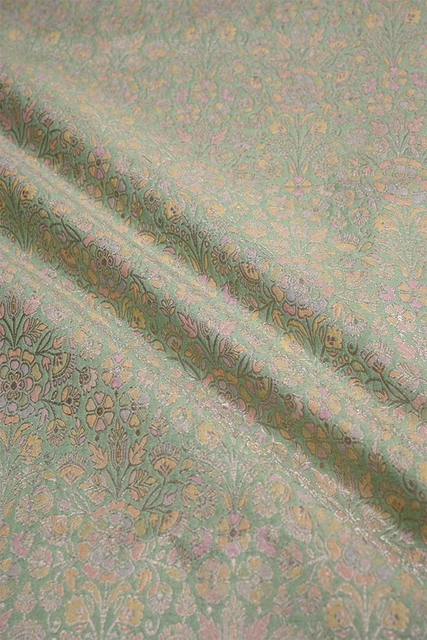 Textured fabric with floral pattern on a green background