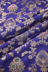 Close-up of Ink Blue fabric with gold zari floral motifs.