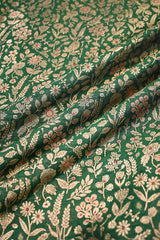 Close-up of Bottle Green fabric with gold zari and meenakari floral jaal pattern