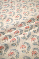 Close-up off Patterned fabric with pink and blue floral design on a beige background
