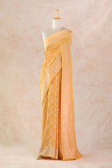 Yellow Saree on a mannequin against a beige background