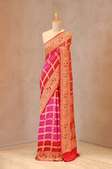Rani Pink and Scarlet Bandhani georgette silk saree with gharchola zari design and peacock floral pallu
