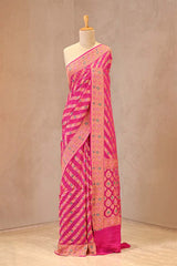Rani Pink geometrical bandhej georgette silk saree with gold zari stripes and floral border pallu