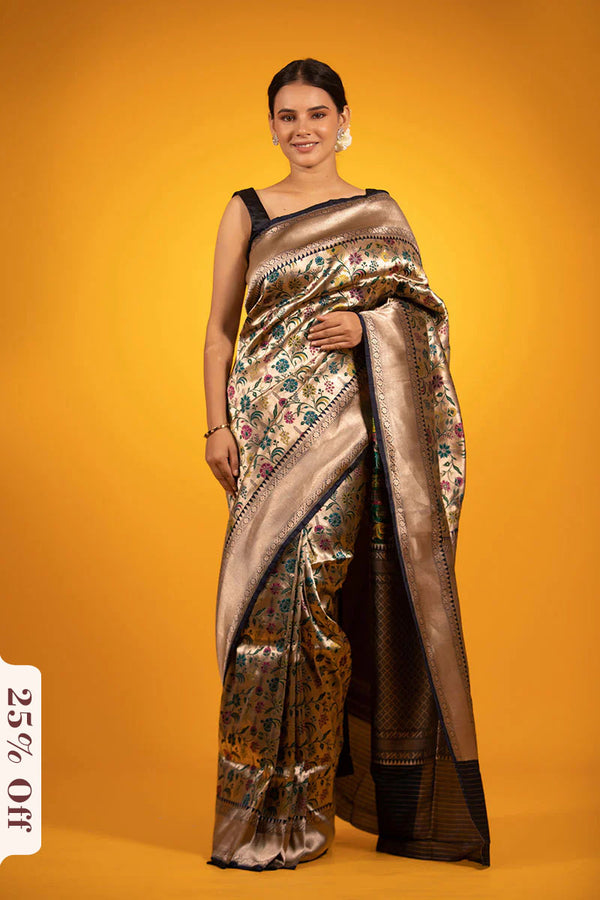 Woman wearing a metallic saree with a floral pattern on an orange background